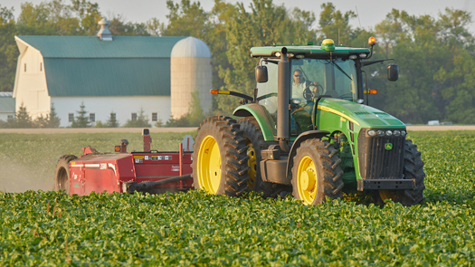 tractor in a field planted with betaseed varieties